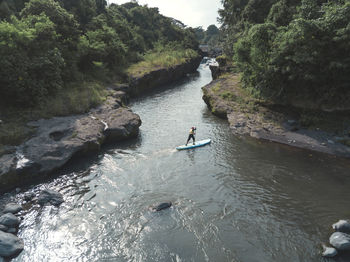 Man paddle boarding the river