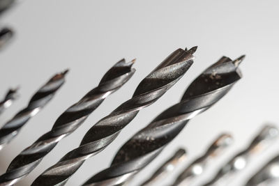 Close-up of metal table against white background