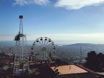 High angle view of ferris wheel in city against sky