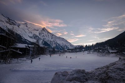 Scenic view of snowcapped mountains against sky during sunset