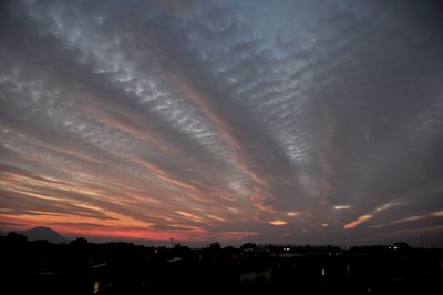 Silhouette buildings against sky during sunset