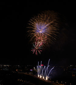 Low angle view of firework display at night