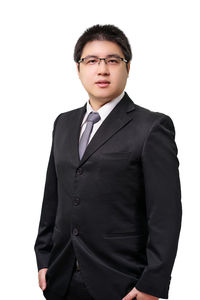 Portrait of young man standing against white background