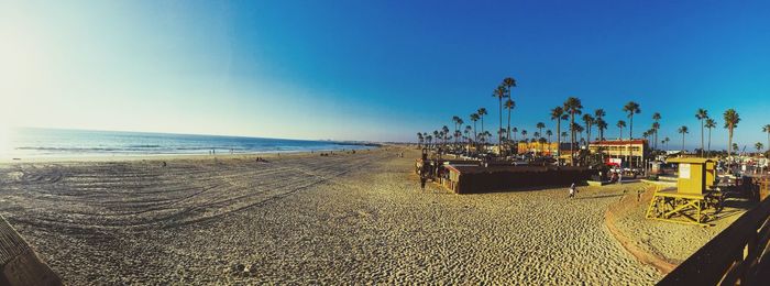 Scenic view of beach against clear blue sky