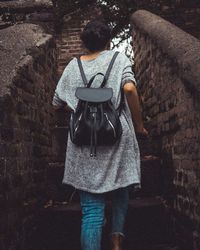 Rear view of teenage girl moving up on steps