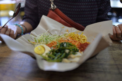 Midsection of person preparing food in restaurant