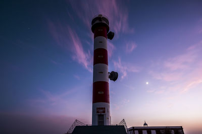 Low angle view of lighthouse against sky during sunset