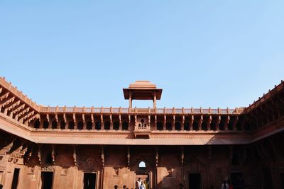 Low angle view of building against clear blue sky