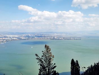 High angle view of sea and cityscape against sky