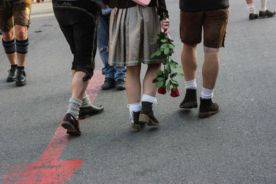 Low section of people walking on road