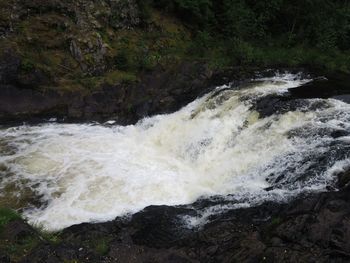 Scenic view of water flowing through rocks