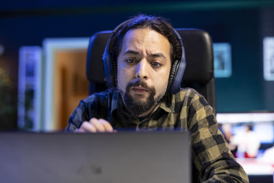 Portrait of young woman using laptop at home