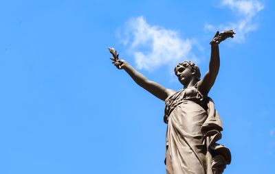 Low angle view of statue against sky