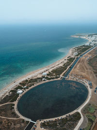 High angle view of swimming pool by sea against sky