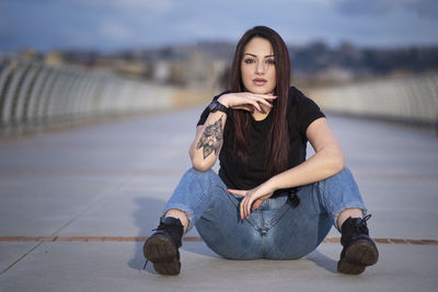 Portrait of young woman sitting outdoors