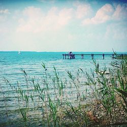 Scenic view of sea against cloudy sky