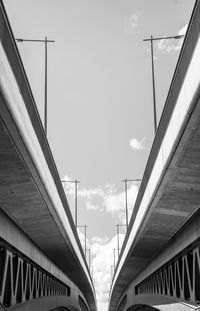 Low angle view of bridge and buildings against sky