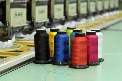 Close-up of multi colored bottles on table