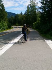 Man riding bicycle on road