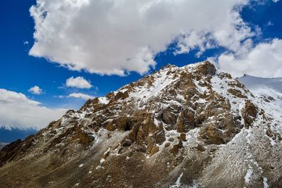 Low angle view of snowcapped mountains against sky