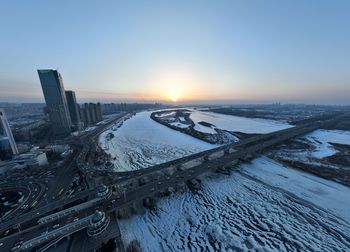 High angle view of city at sunset