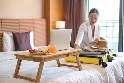 Woman sitting on table at home