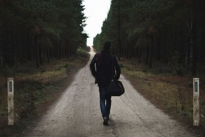 Man on footpath in forest