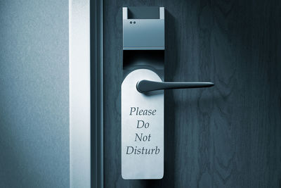 Close-up of do not disturb sign on door handle
