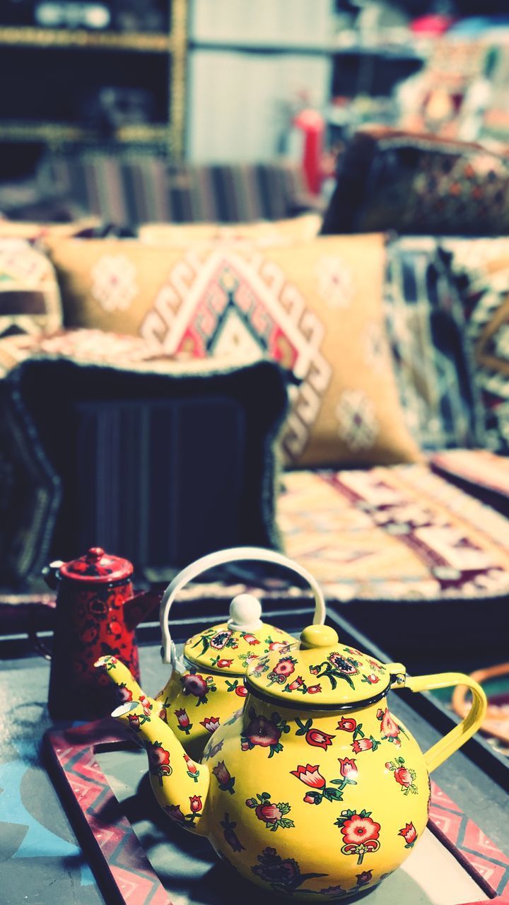 CLOSE-UP OF TEA CUP ON TABLE AT CAFE