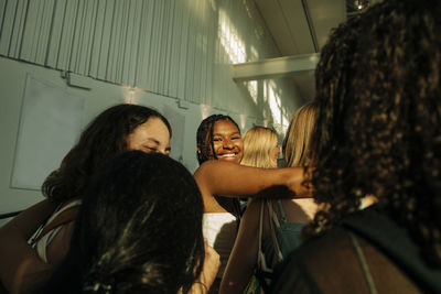 Smiling teenage girl with female friends in shopping mall