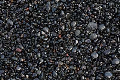 Full frame shot of wet pebbles at beach