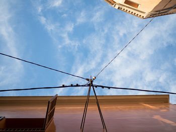 Low angle view of cables against sky