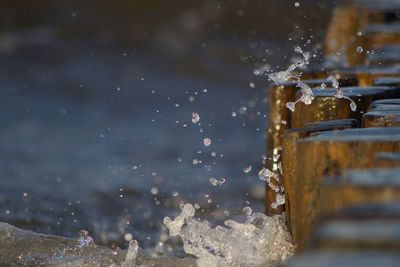 Close-up of water splashing on glass