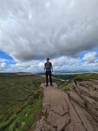 Full length of man standing on landscape against sky