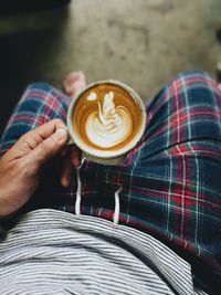 Midsection of woman holding coffee cup