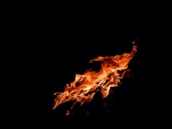Close-up of fire over black background