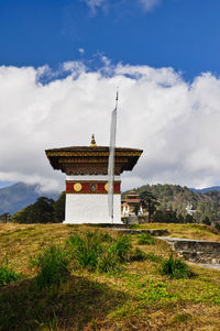 Built structure on field against sky