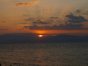 Scenic view of sea against romantic sky at sunset