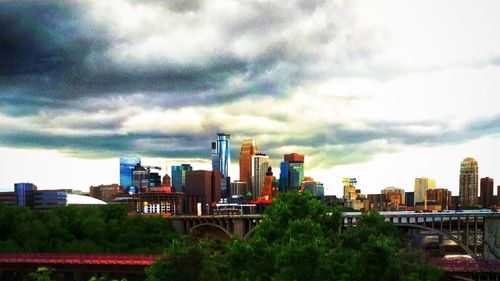 Cityscape against cloudy sky