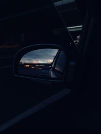 Reflection of bridge in car side-view mirror