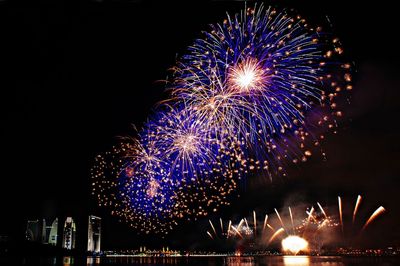 Low angle view of firework display at night