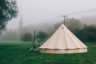 Tent on field against sky