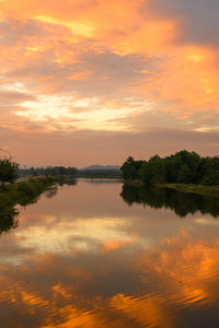 Scenic view of lake against orange sky