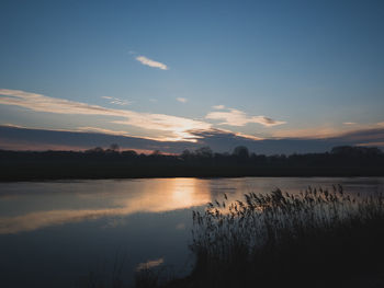 Scenic view of lake against sky during sunset