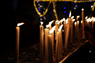 Close-up of lit candles in temple