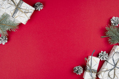 Close-up of christmas tree against red wall