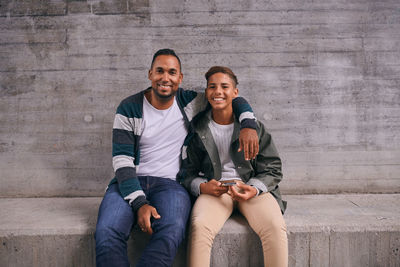 Portrait of young couple sitting outdoors