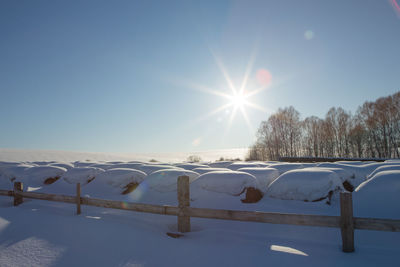 Scenic view of snow covered landscape against bright sky