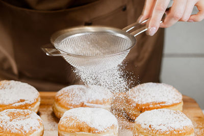 Cropped hand of man preparing food