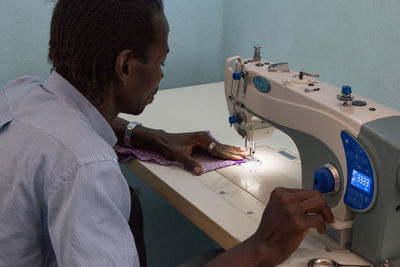 Side view of woman working in workshop